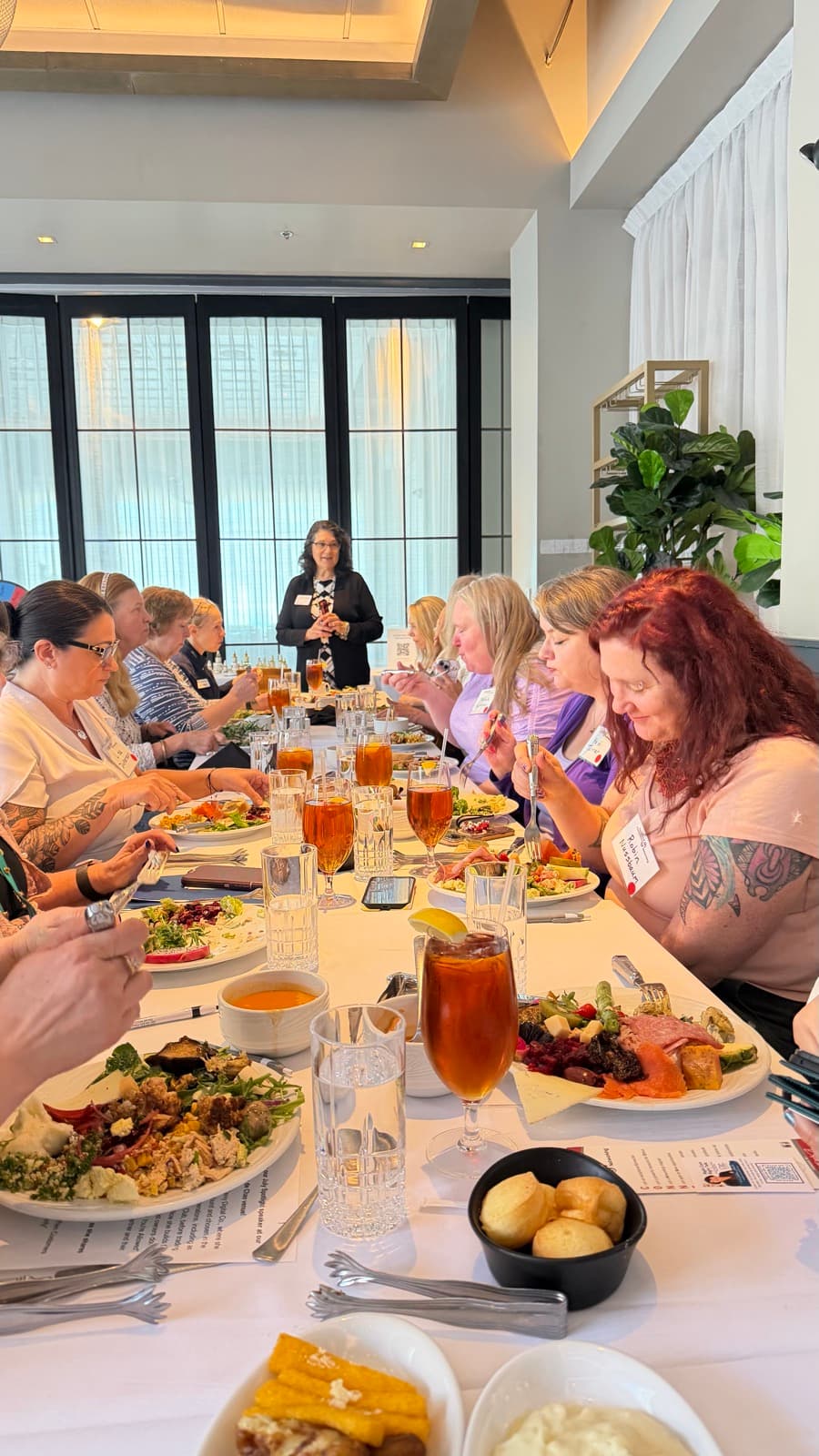 Guests at the July Exceptional Connections networking luncheon at Fogo de Chao in Lynnwood, Washington, with a speaker addressing the table