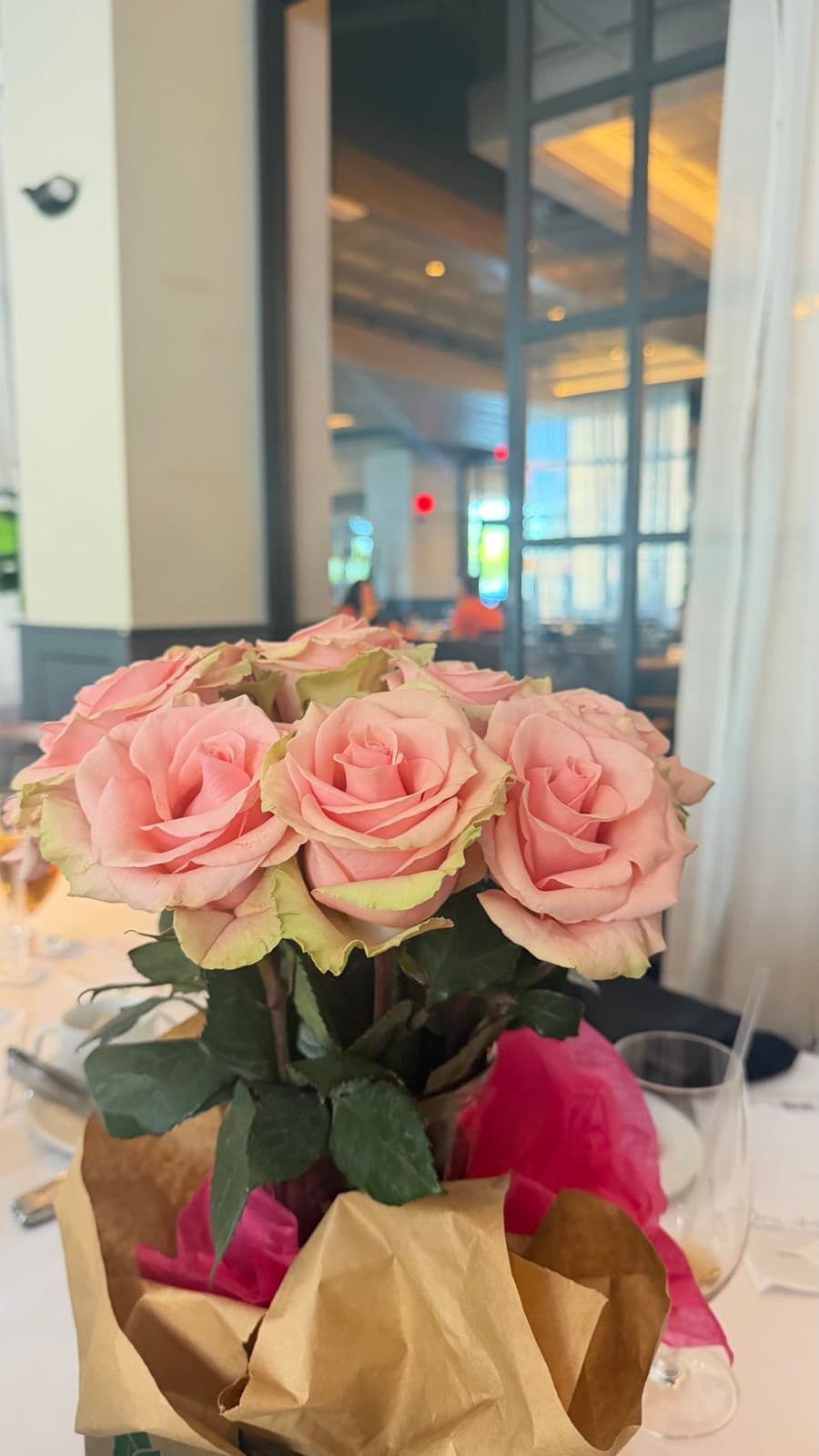 A bouquet of pink roses on the table at the Exceptional Connections luncheon